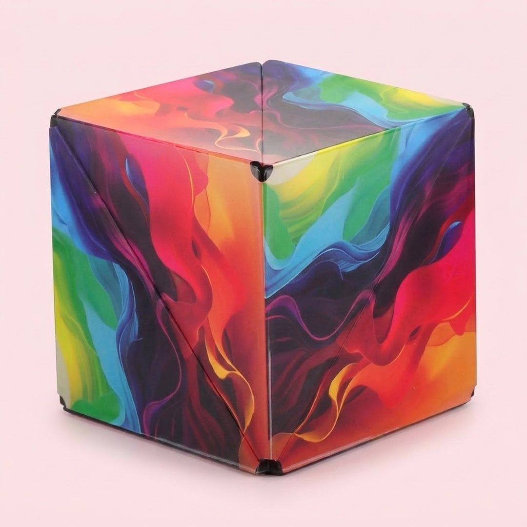 ABS plastic puzzle cube with rainbow wave patterns and visible diagonal seams, shown closed against a pale pink background.