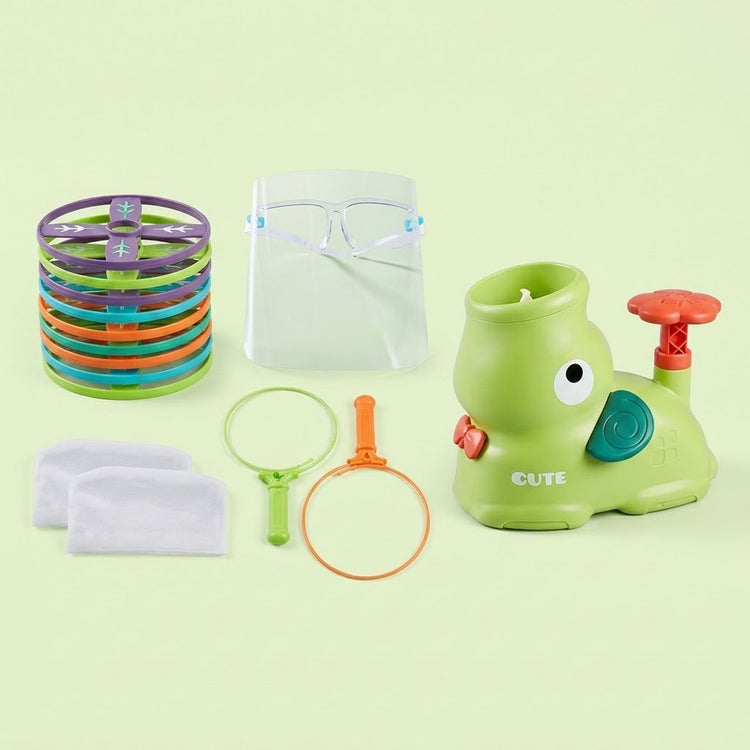A green elephant-shaped disc launcher set includes stacked colorful discs, net components, and a clear face shield against a pale green background.