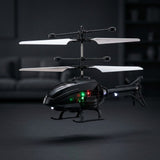 A black remote control toy helicopter with white rotors and illuminated green and red indicator lights, shown hovering against a dark, blurred indoor background.