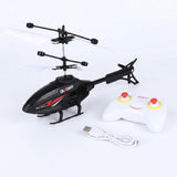 Black RC remote control helicopter toy with red and white graphic accents, shown with a white remote control controller and a white USB charging cable on a white background.
