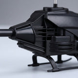 A close-up shows the black remote control helicopter's textured body, side vents, and landing skids against a gray background.