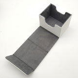 An empty white deck box with gray lining and front access cutouts rests open with its flap extended on a white background.