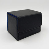 A black textured deck box with blue edge trim and a closed front flap sits on a light gray background.