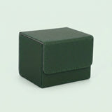 A dark green textured deck box with a closed stitched front flap sits on a pale green background.