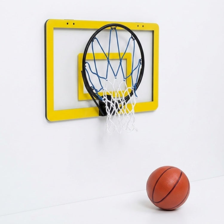A wall-mounted basketball hoop with a bright yellow backboard and rim, shown against a white wall with a small orange basketball on the floor below.