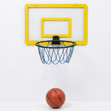 A wall-mounted mini basketball hoop with a yellow backboard, black rim, blue net, and a small orange basketball below, shown against a plain white wall and floor.