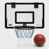 A wall-mounted basketball hoop set with a clear backboard, black rim, blue net, and a red basketball on a light gray background. The backboard shows the brand name SPORT.