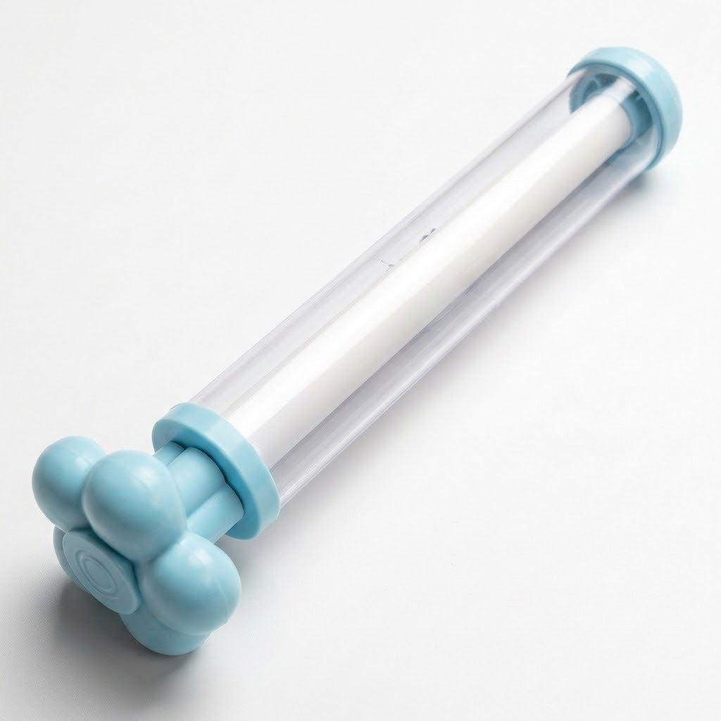 A clear water gun with light blue ends, a flower-shaped handle, and a white inner tube lies diagonally on a white background.
