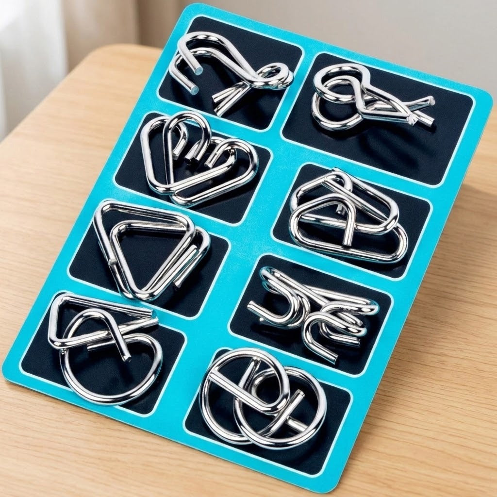 Eight-piece silver-colored wire brain teaser set displayed at an angle on a turquoise and black backing card on a wooden table.