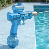 A translucent blue electric water gun with an upper tank and round lower tank sprays water beside a turquoise swimming pool.