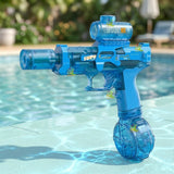 A translucent blue electric water gun with a round lower tank stands beside a swimming pool with blurred greenery behind it.
