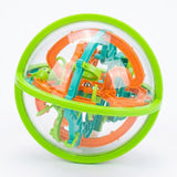 A complete maze puzzle with a clear plastic shell, lime-green rim, colorful tracks and visible steel ball sits against white.