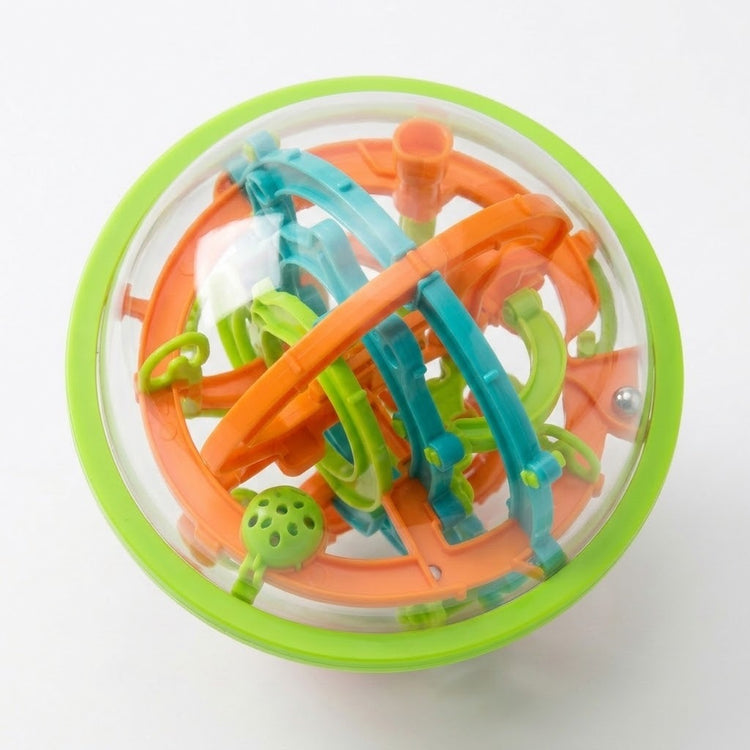 An elevated view of the spherical maze puzzle reveals overlapping orange, teal and lime-green tracks through its transparent shell against white.