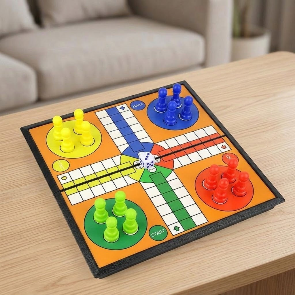 A square Ludo board game set on a light wood table with a blurred sofa in the background. The game board is orange with a black border, featuring blue, green, yellow, and red path sections, and multicolored pawns.