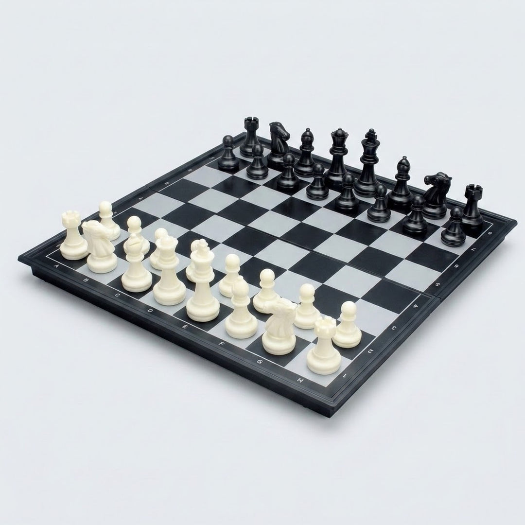 Ludo game set shown with a chessboard side up, black and white chess pieces arranged in starting positions on a plain light background.