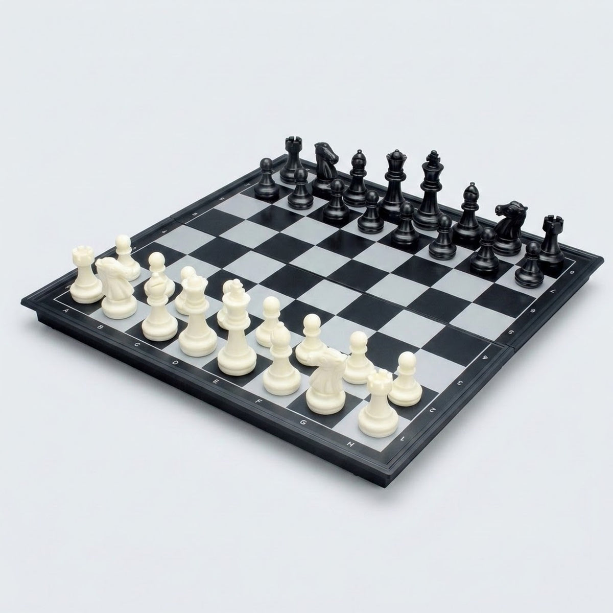 Ludo game set shown with a chessboard side up, black and white chess pieces arranged in starting positions on a plain light background.