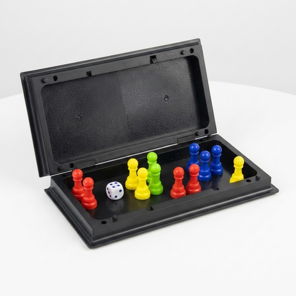An open black plastic ludo set holds upright red, yellow, green and blue pawns with a white die against a white background.