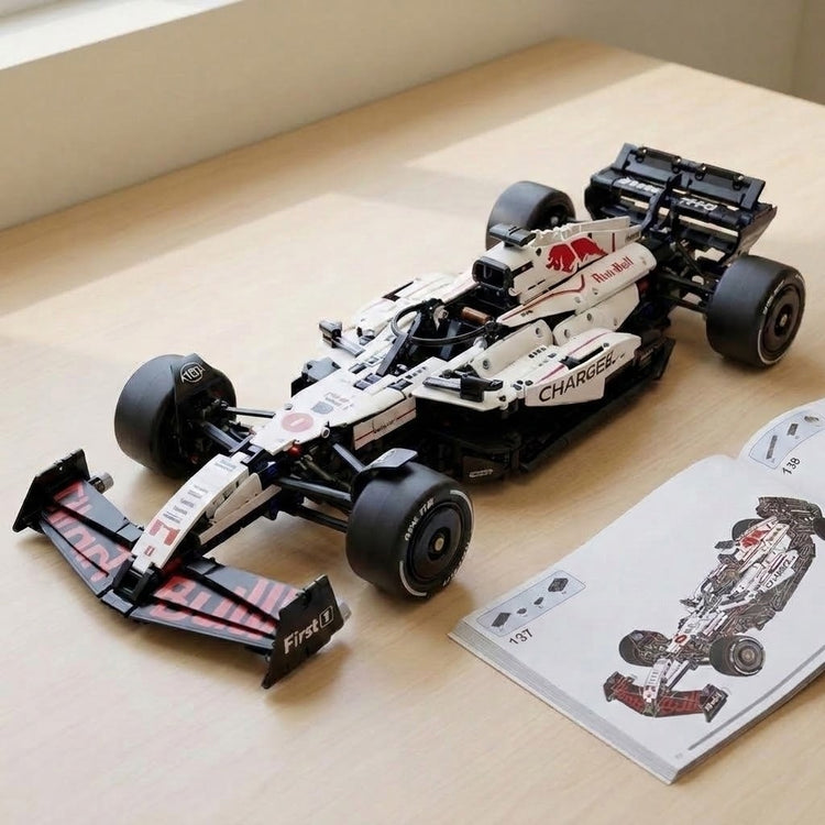White and black building-block race car with red accents sits beside an open assembly manual on a light wooden tabletop.