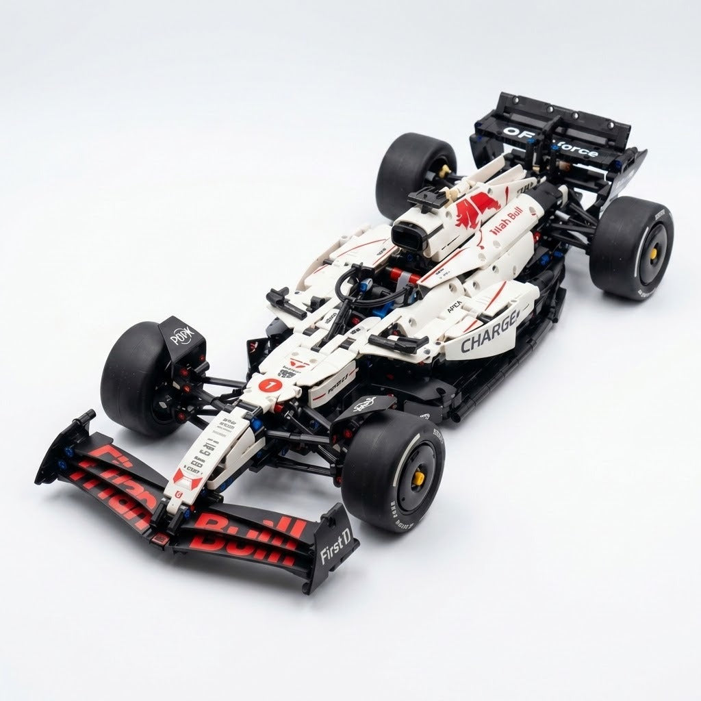 White and black building-block race car with red accents and wide tires is viewed diagonally from above against a white background.