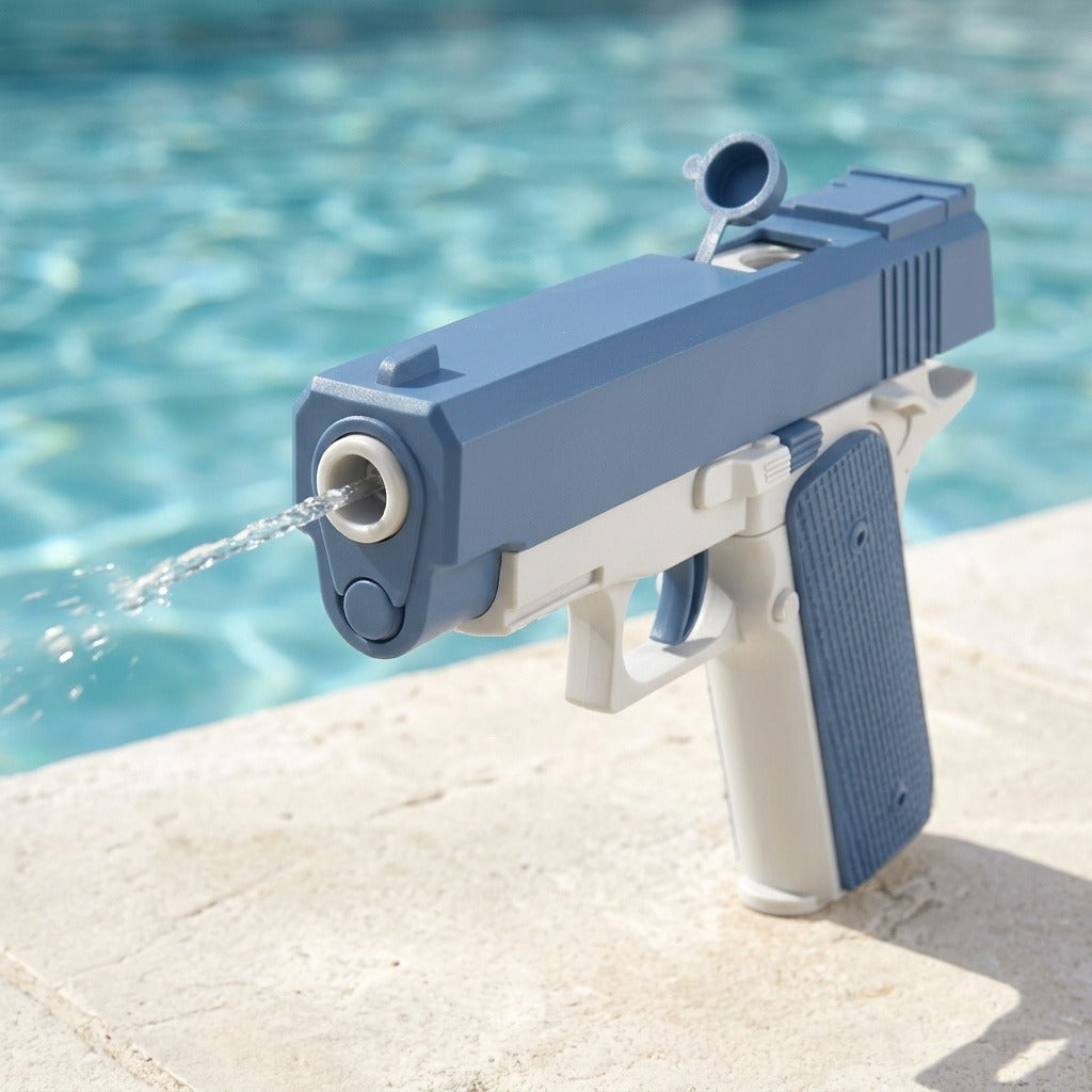 A blue and white water gun sprays a stream of water while standing on a stone ledge beside a pool.