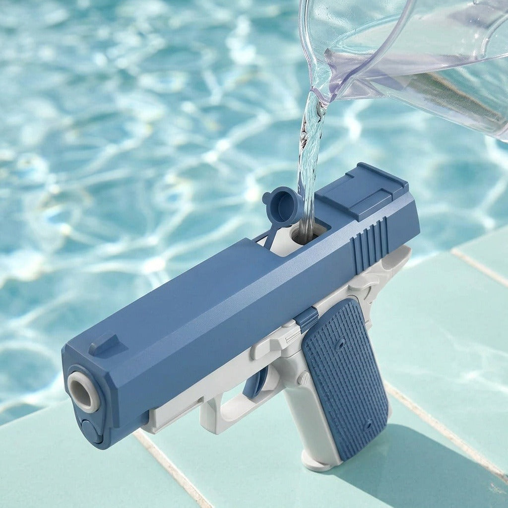 Water pours from a clear jug into the blue and white water gun's open filling port on poolside tiles.