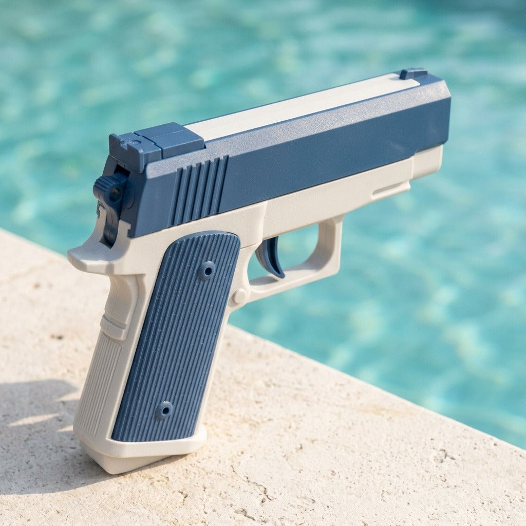 Blue-and-white water squirt gun with a textured grip stands on pale poolside stone, viewed from behind against turquoise water.