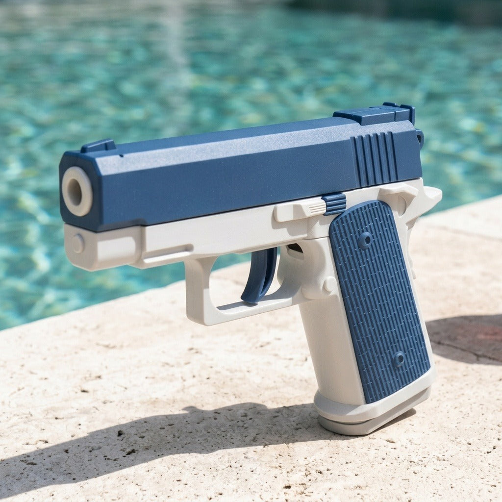 Blue-and-white water squirt gun with a round nozzle and textured grip stands on sunlit pale stone beside turquoise pool water.