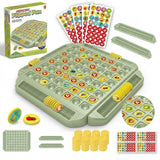 A memory matching game set on white includes a green board, yellow pieces, fruit stickers, detachable trays, and a box.