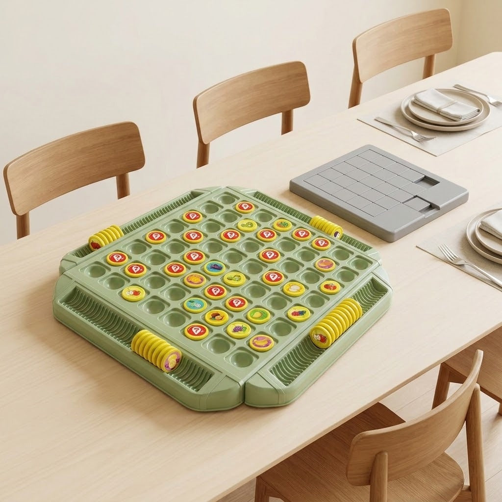 Green memory matching game with yellow tokens beside a gray rectangular accessory on a dining table set with plates and cutlery.