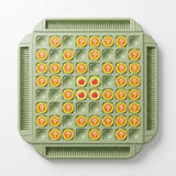 A green memory matching game on white has yellow question-mark pieces, empty recesses, and four revealed apple pieces in the center.