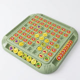 An angled green memory matching game on white displays yellow fruit and question-mark pieces, with upright pieces arranged in edge trays.