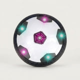 A hover soccer ball stands upright against an off-white background, showing black and white panels, a purple center, and colored lights.