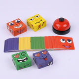A colorful children's card and block game set on a light gray background, featuring four cube pieces with cartoon faces, a fan of matching cards, and a red bell.