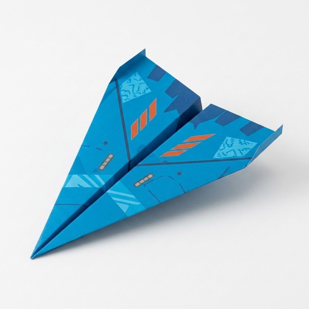 Blue paper airplane folded from this origami kit, printed with orange stripes and upturned wingtips, sits on a plain white background.