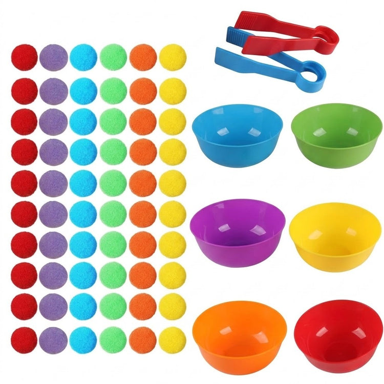 Sorting toy with 60 rainbow pom poms in columns, six colorful plastic bowls and red and blue tweezers on a white background.