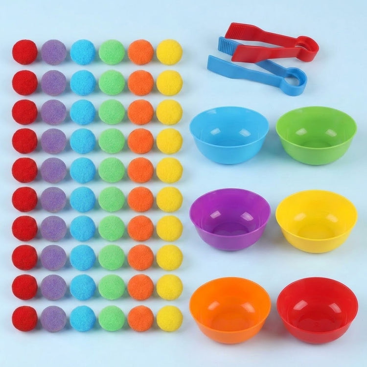 Sorting toy set on a light blue background with a grid of rainbow pom poms, six empty plastic bowls, and two tweezers.