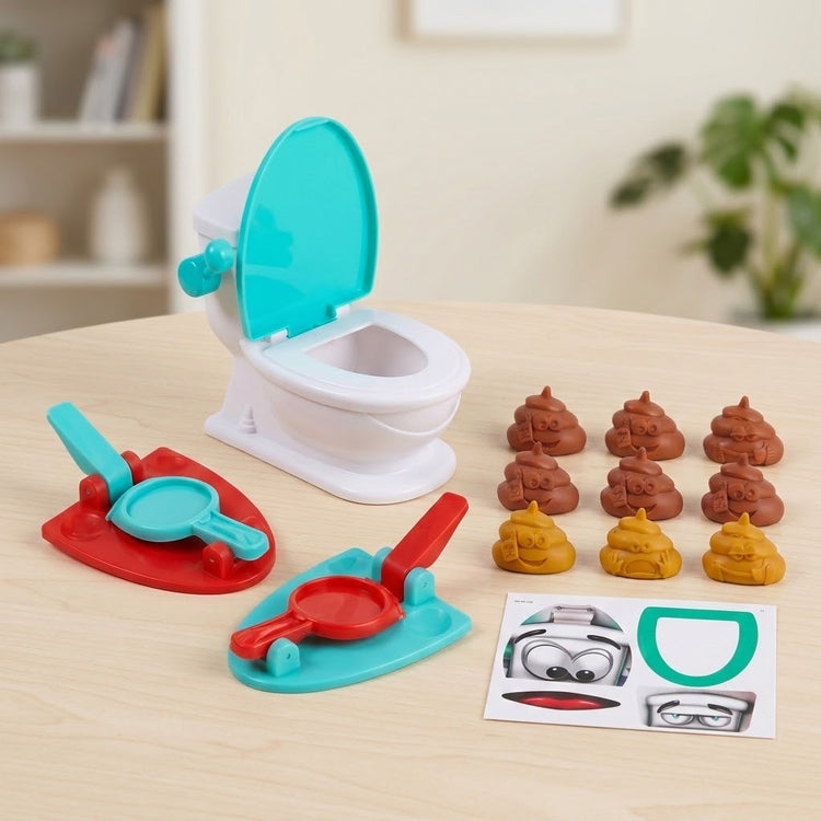 Tabletop game with a white-and-turquoise toilet target, two launchers, toy poops, and a sticker sheet on a wooden table.