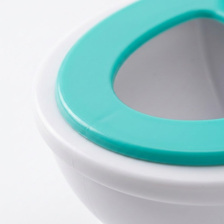 Close-up of the tabletop game's white plastic toilet target and smooth turquoise seat rim against a white background.