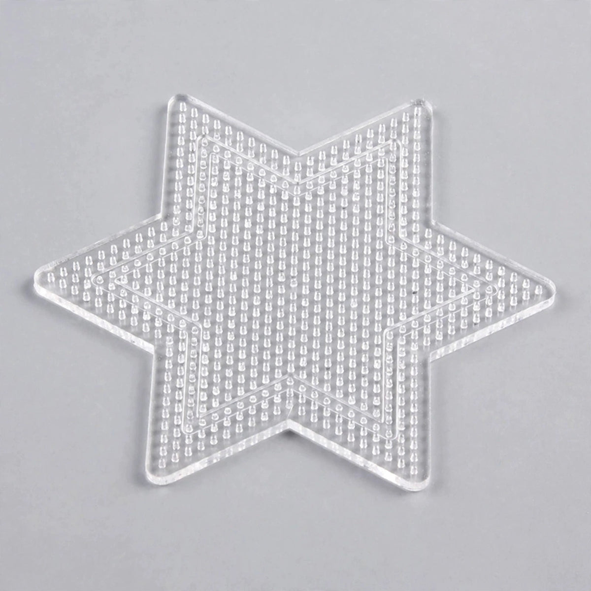 Clear six-pointed star plastic pegboard with rows of small pegs and an inner star outline on a light grey background.