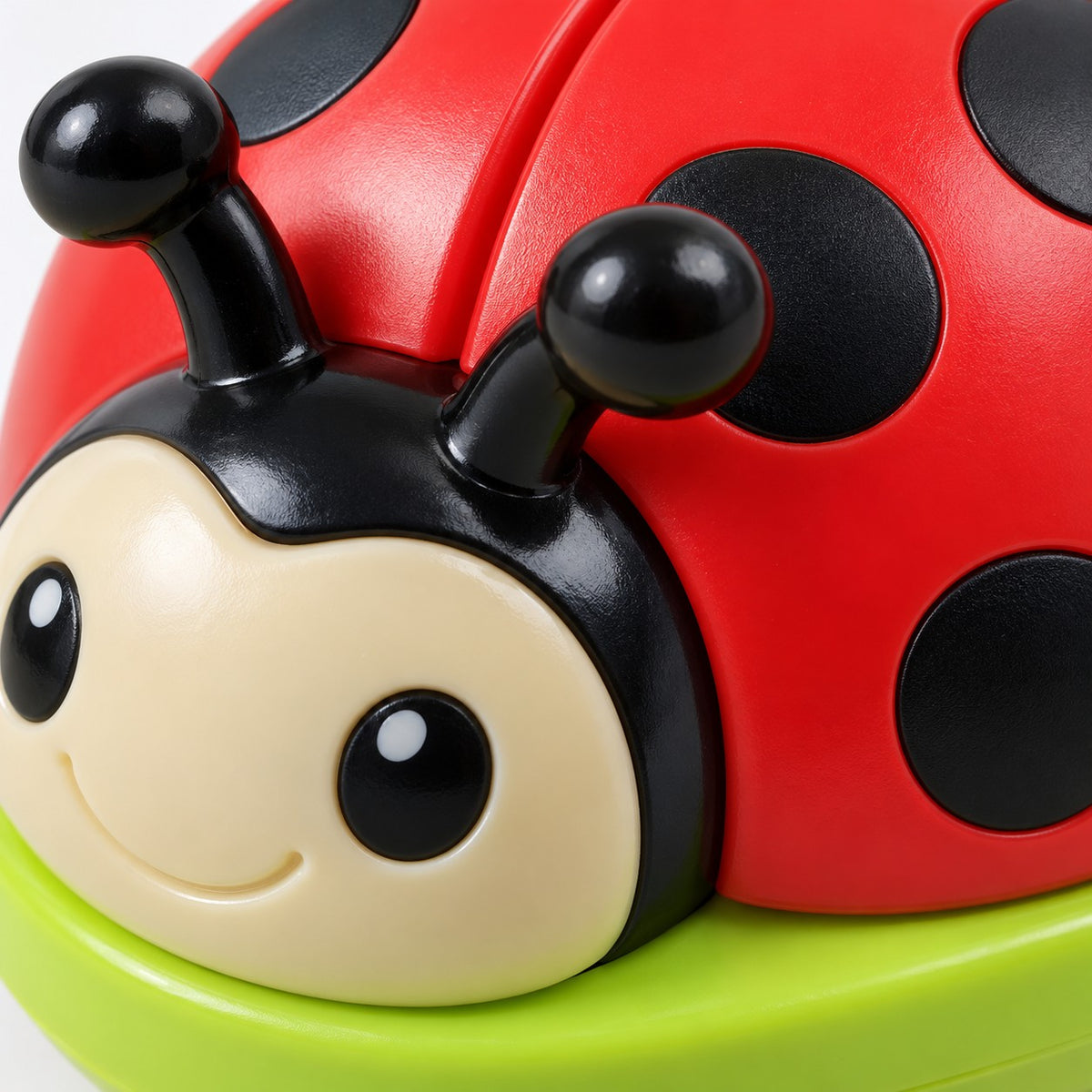 Ladybug Activity Toy Set close-up shows the smooth red plastic shell, black spots and green base.