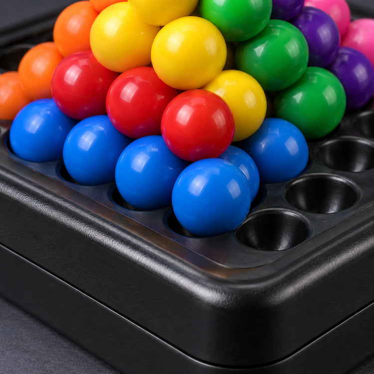Pyramid Bead Puzzle Game close-up shows glossy beads, molded plastic and round board recesses.