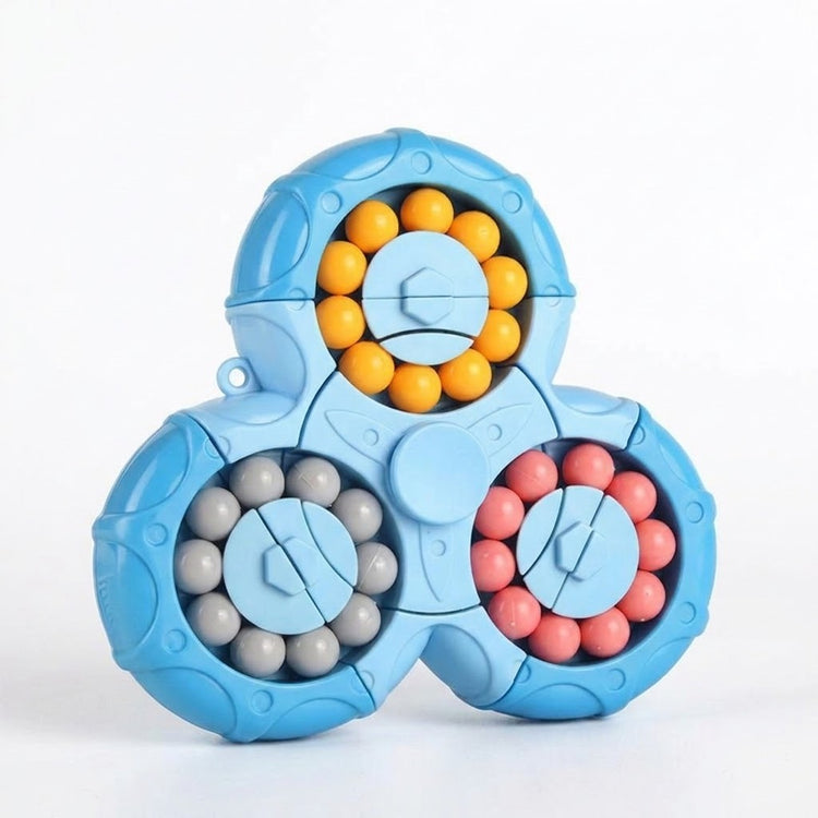 Blue plastic fidget puzzle with three rounded lobes and yellow, gray, and pink beads stands against a white background.