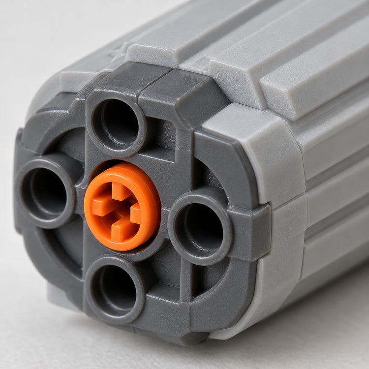 Macro detail of the MOC Power Functions motor's ribbed gray plastic housing and orange connector.