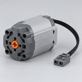 XL Motor variant with a chunky gray housing, orange shaft connector and attached cable on a studio backdrop.