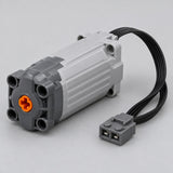 Servo Steering Motor with its rounded gray interface, orange connector and attached black cable.