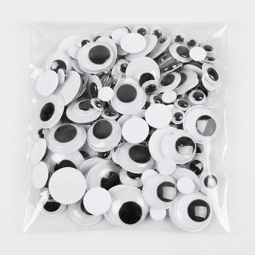 A clear plastic bag filled with many white googly eyes with black centers, photographed on a plain white background.