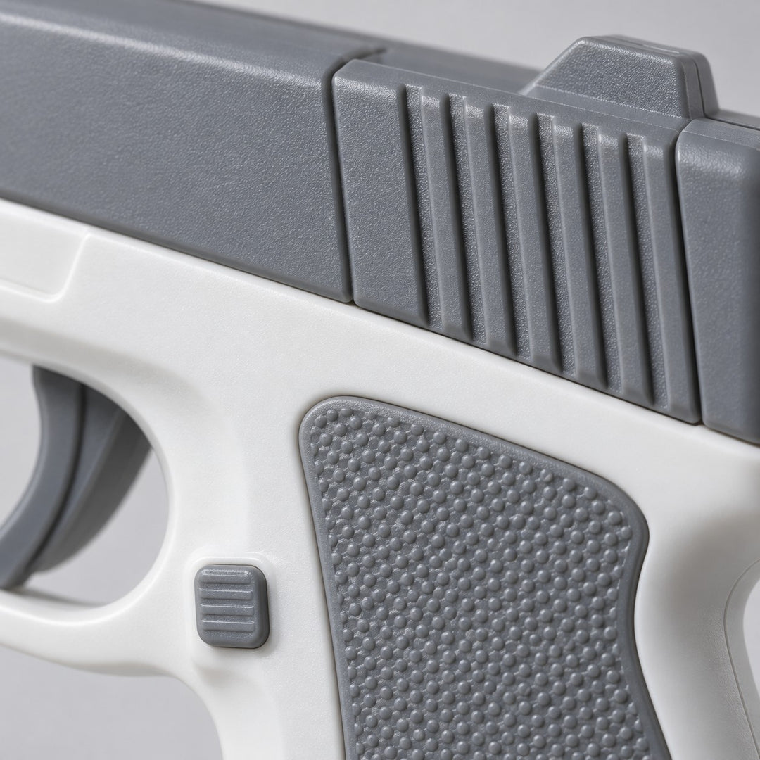 A close macro view shows the gray molded plastic slide, textured grip, and smooth white body of the water pistol.