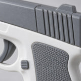 A close macro view shows the gray molded plastic slide, textured grip, and smooth white body of the water pistol.