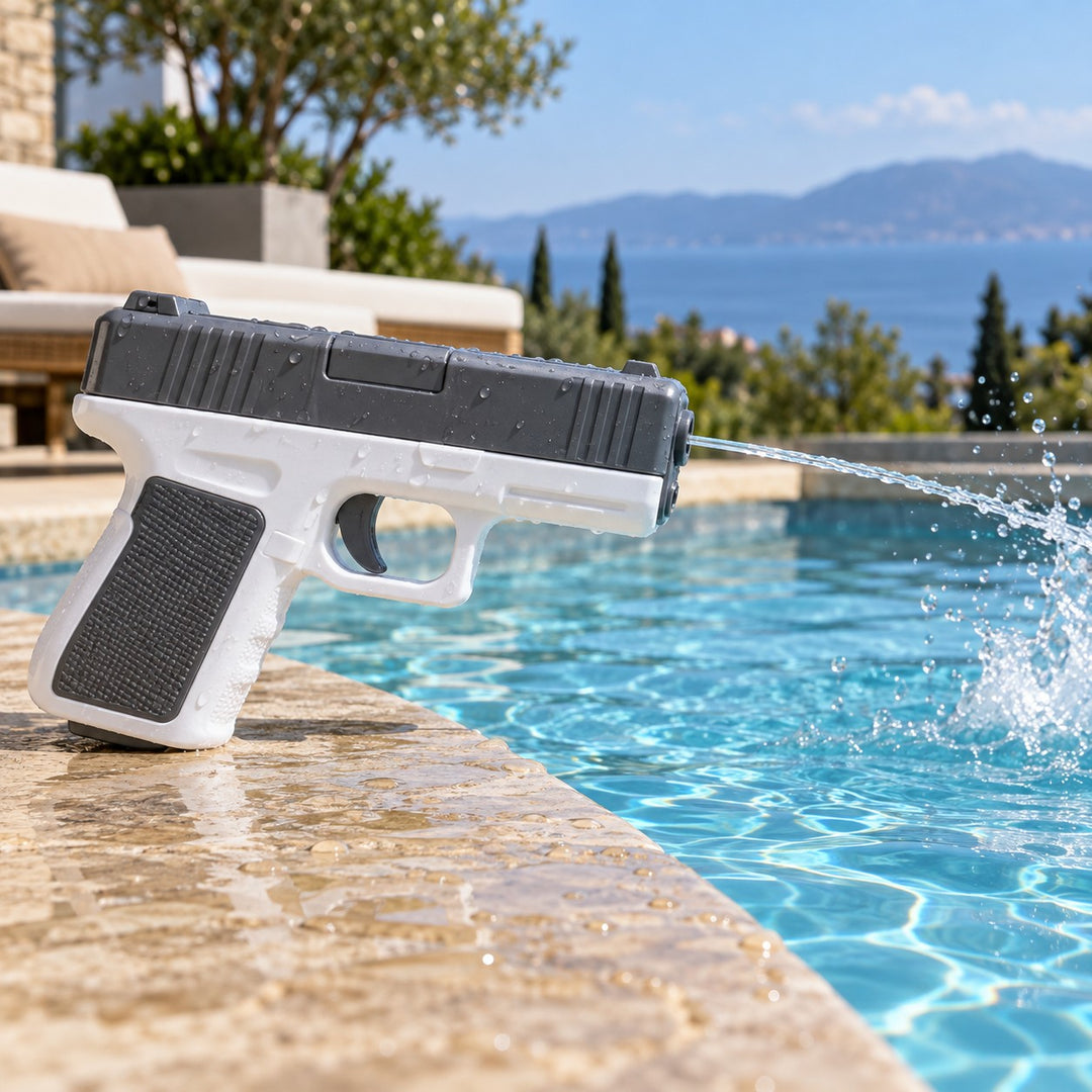 A gray and white water pistol sends a stream into a pool during a sunny outdoor play moment.