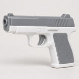 The gray and white water pistol is centered on a soft gray studio background with a light shadow.